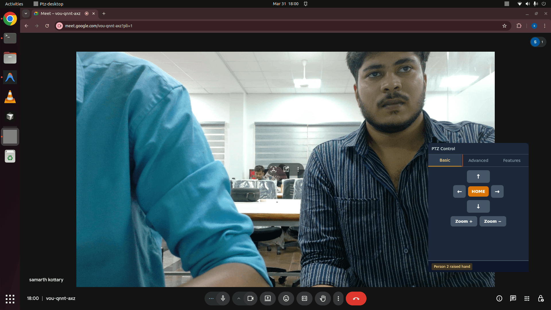 PTZ control panel auto-framing a speaker during a Google Meet call, with hand-raise detection
